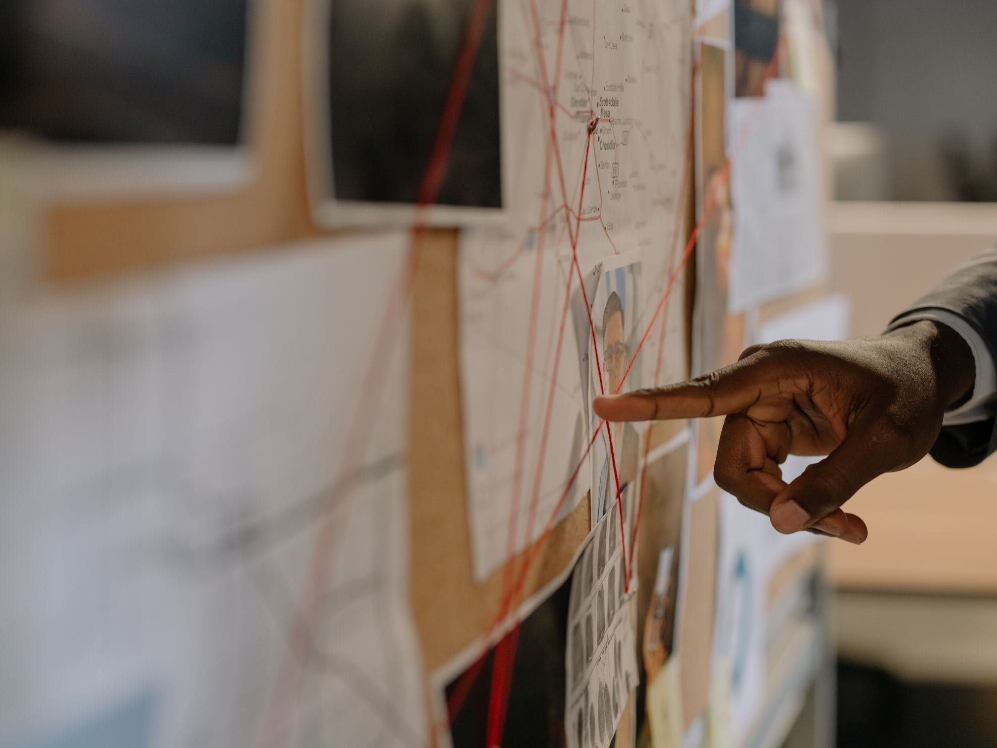 Person pointing at an investigation board